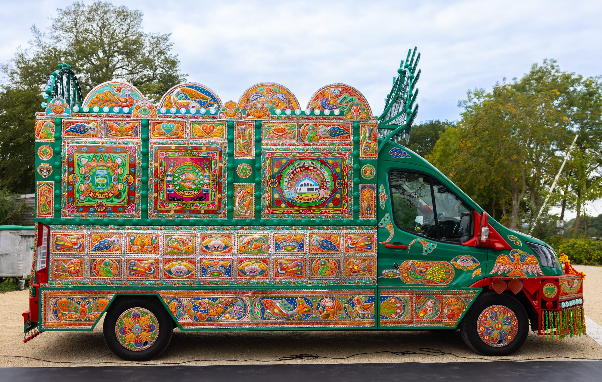 a side view of a colorful van that has been transformed into an artwork