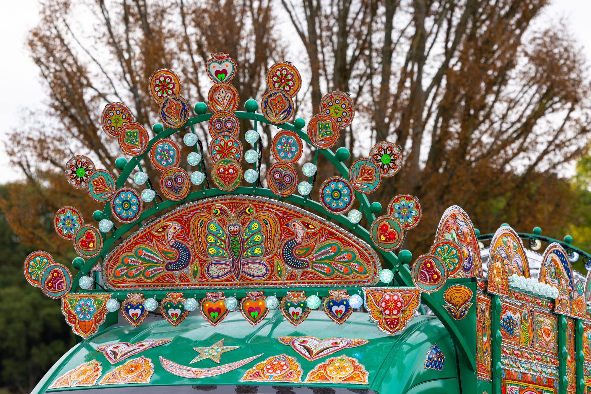 a detail of a sculptural crown-like piece on a colorful van that has been transformed into an artwork