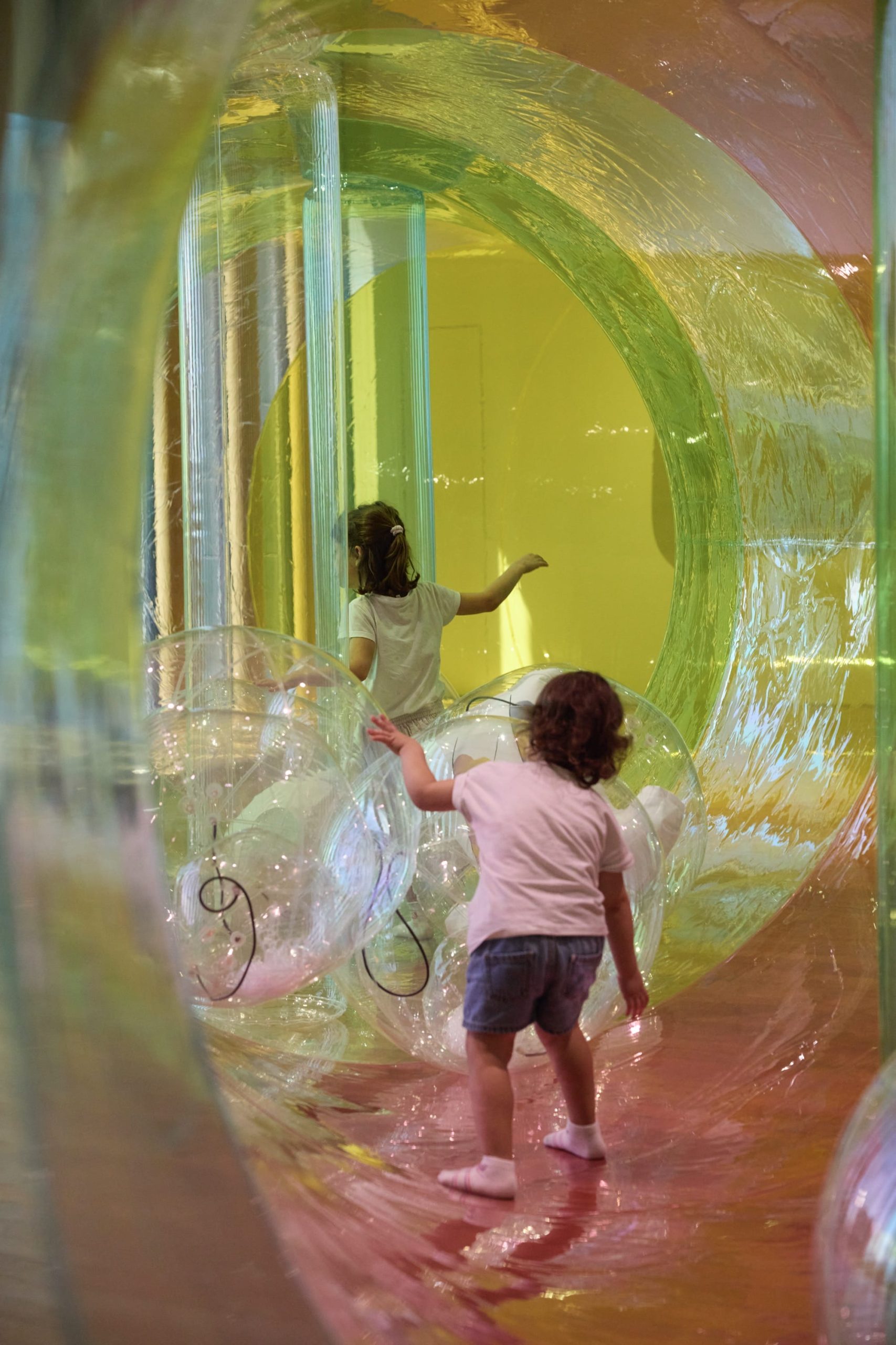children run through a colorful environment