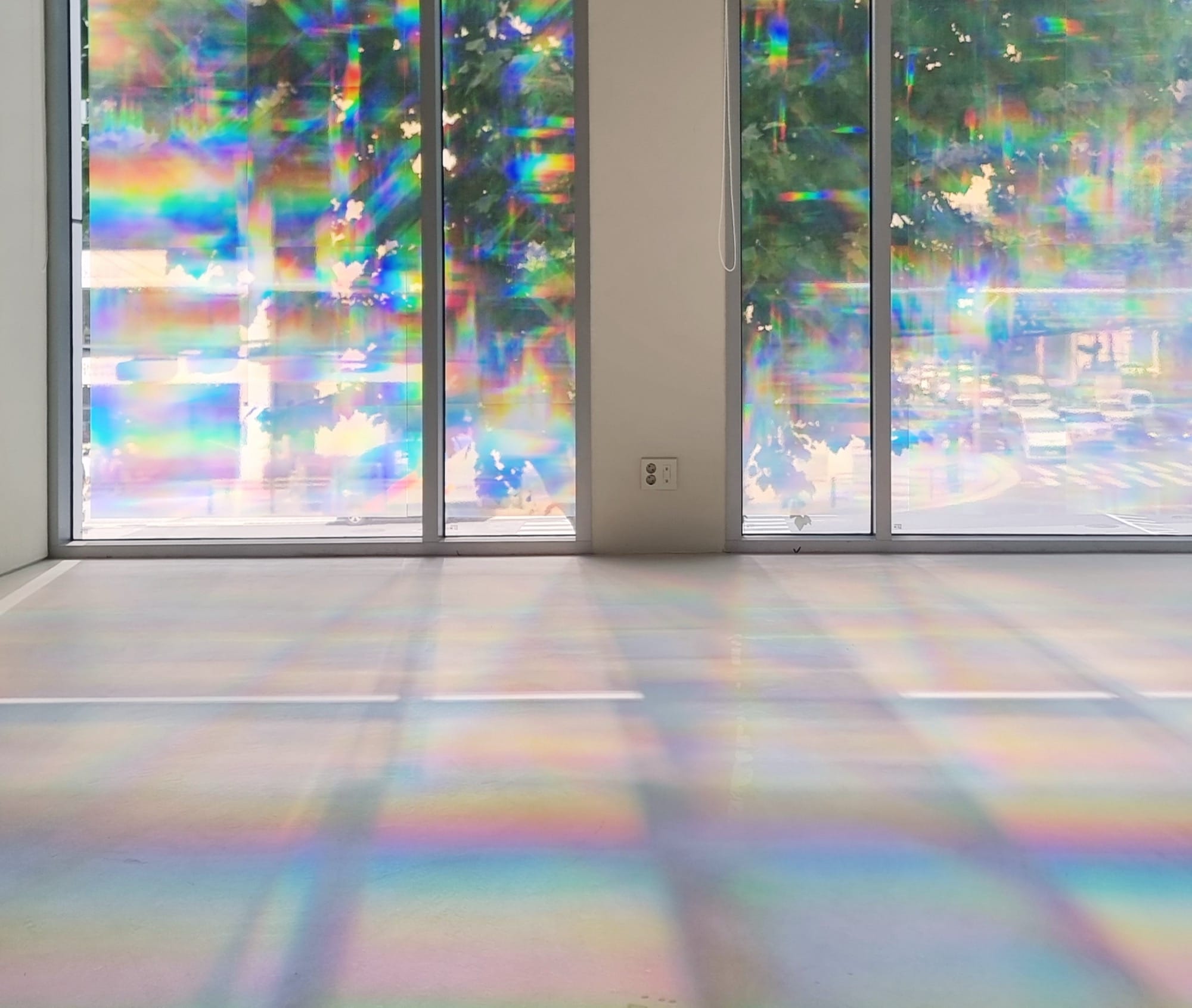 a glass windowed room with prismatic shadows
