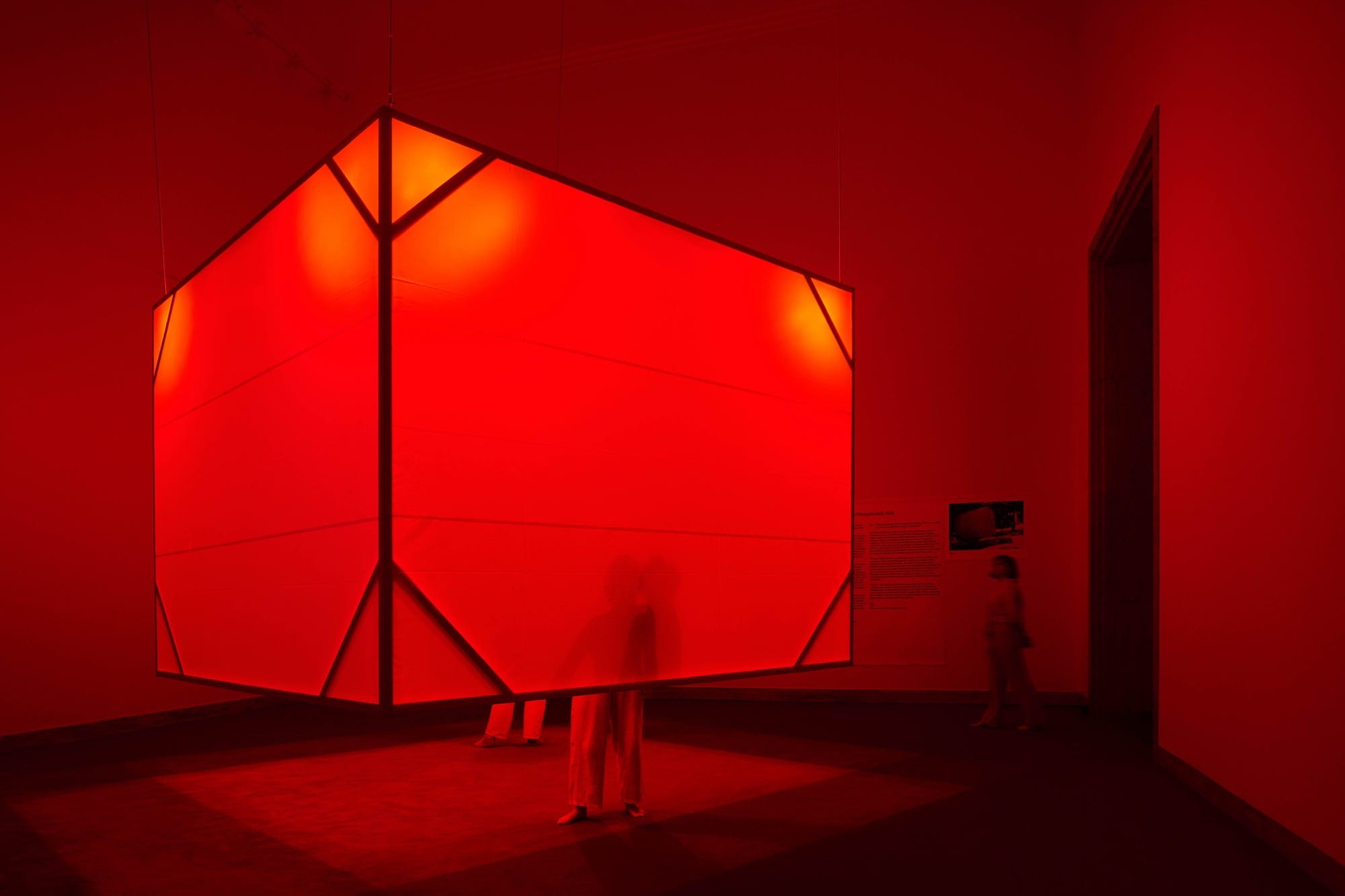 a person stands in a glowing red cube