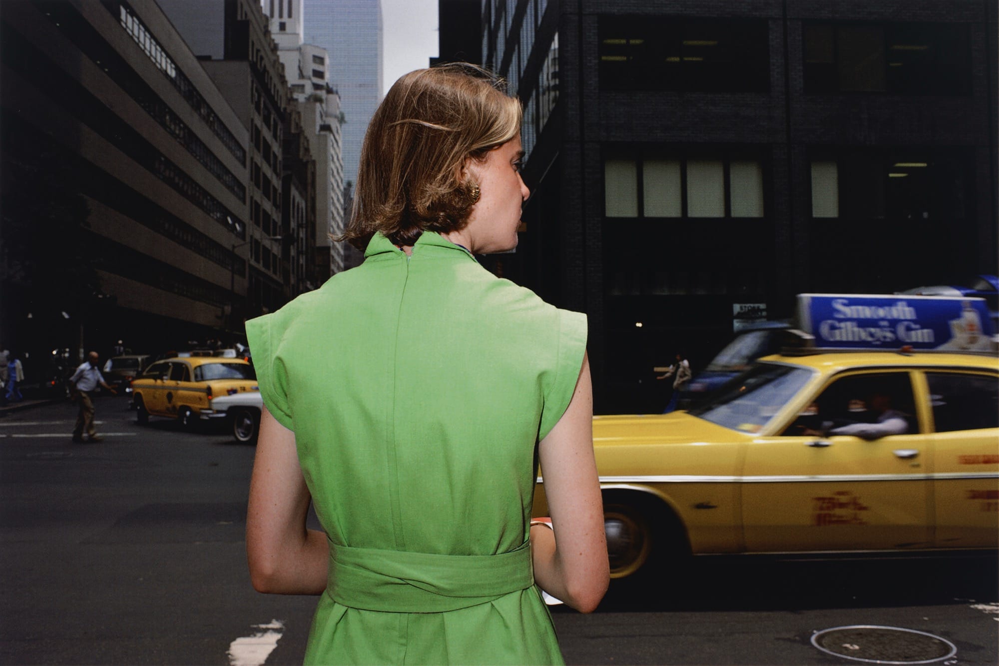 a photo by Joel Sternfield of a woman in New York, with her back to the camera, wearing a green dress
