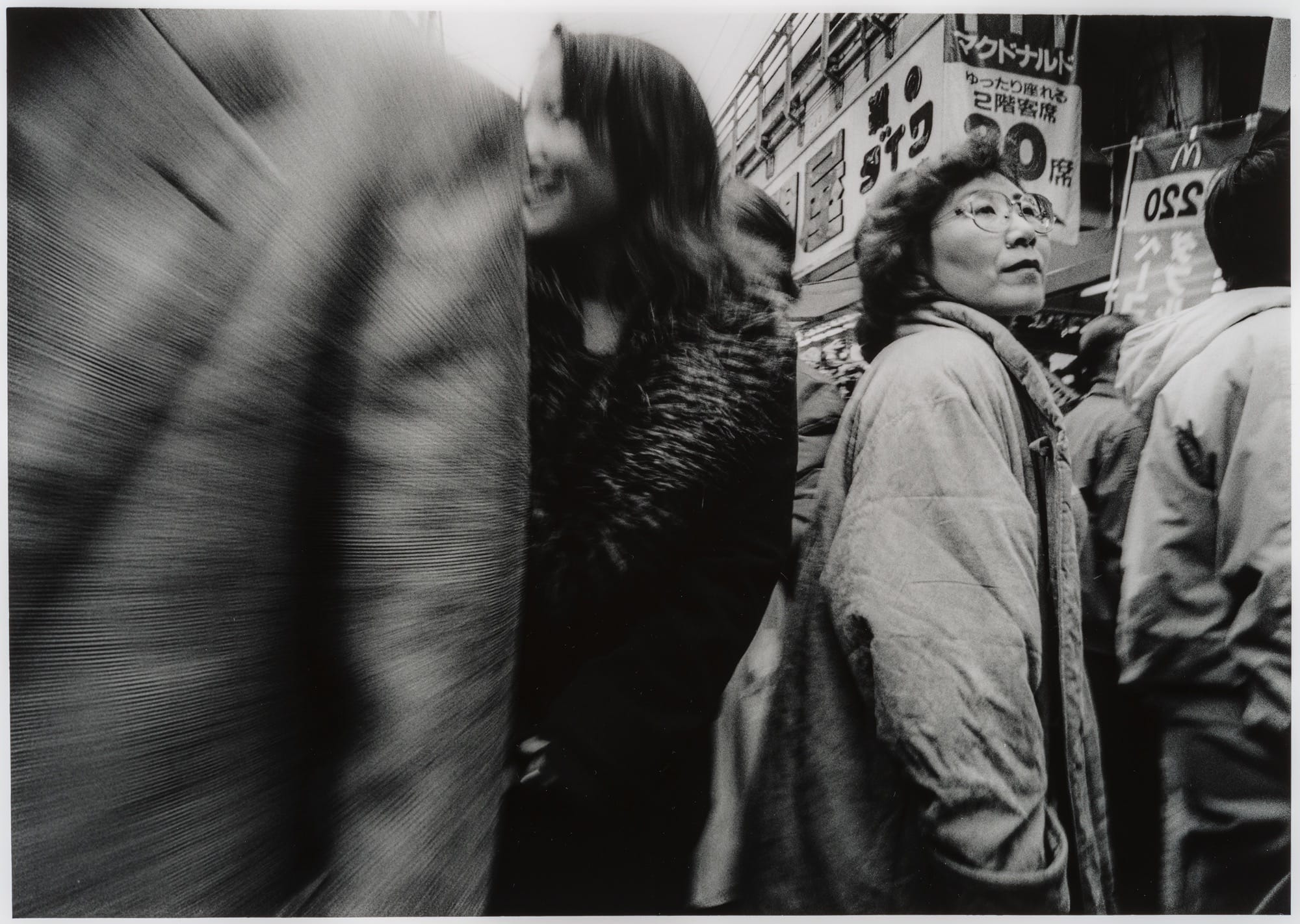 A black-and-white photo by Yasuhiro Ishimoto of people on a crowded street in Japan