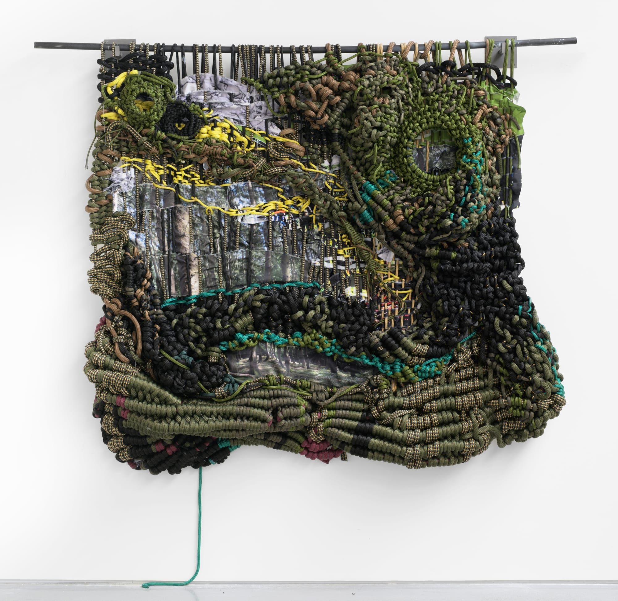 a knotted rope work by Jacqueline Surdell hanging from a bar
