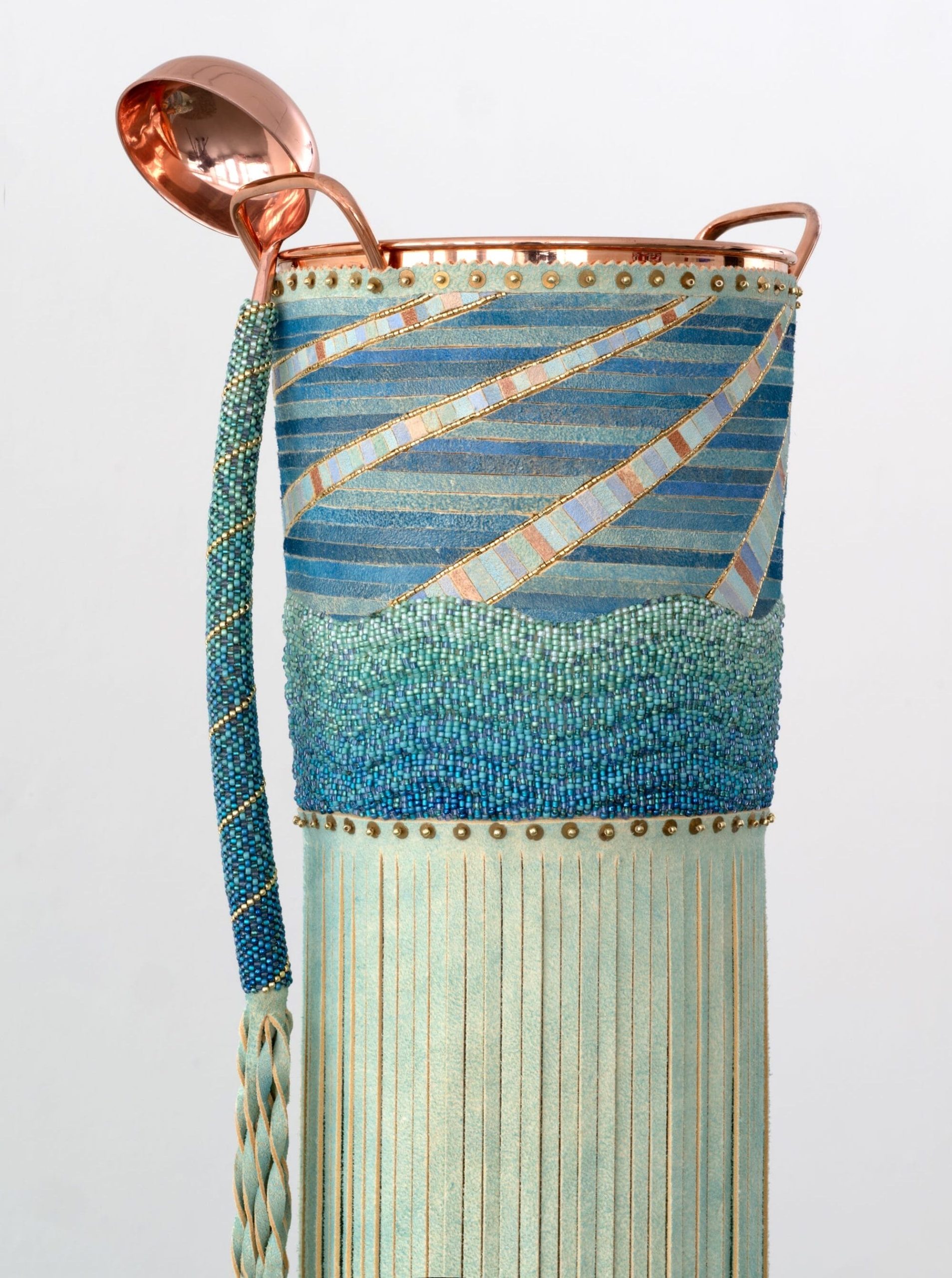 a detail of a beaded, leather, and metal sculpture by Dyani White Hawk