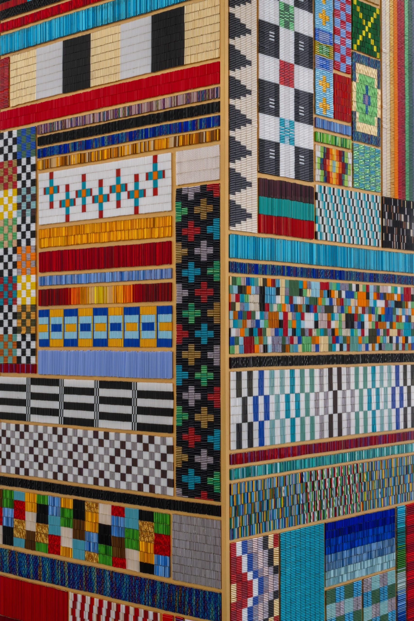 a detail of a geometric sculpture by Dyani White Hawk coated in patterns of beadwork